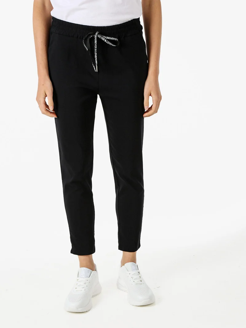 Pantaloni donna elasticizzati con coulisse - nero