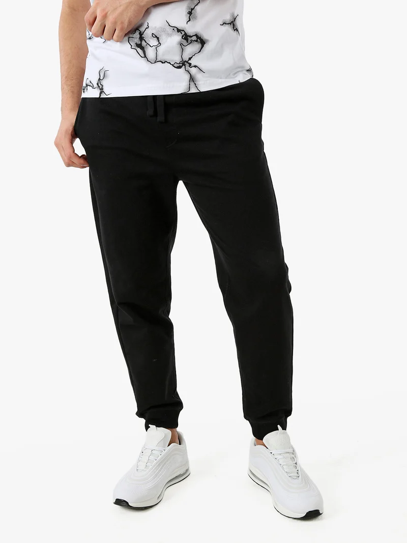 Pantaloni tuta da uomo con coulisse e polsini - nero
