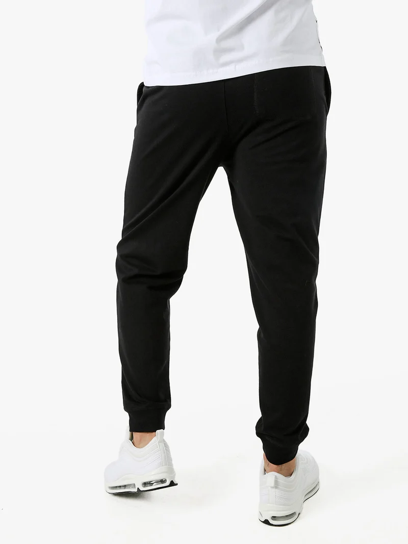 Pantaloni tuta da uomo con coulisse e polsini - nero
