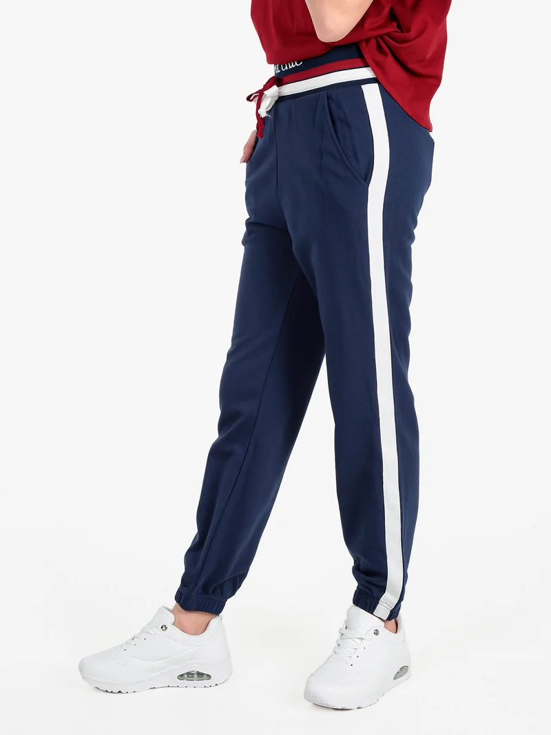 Pantaloni tuta da donna con coulisse e polsini - blu scuro