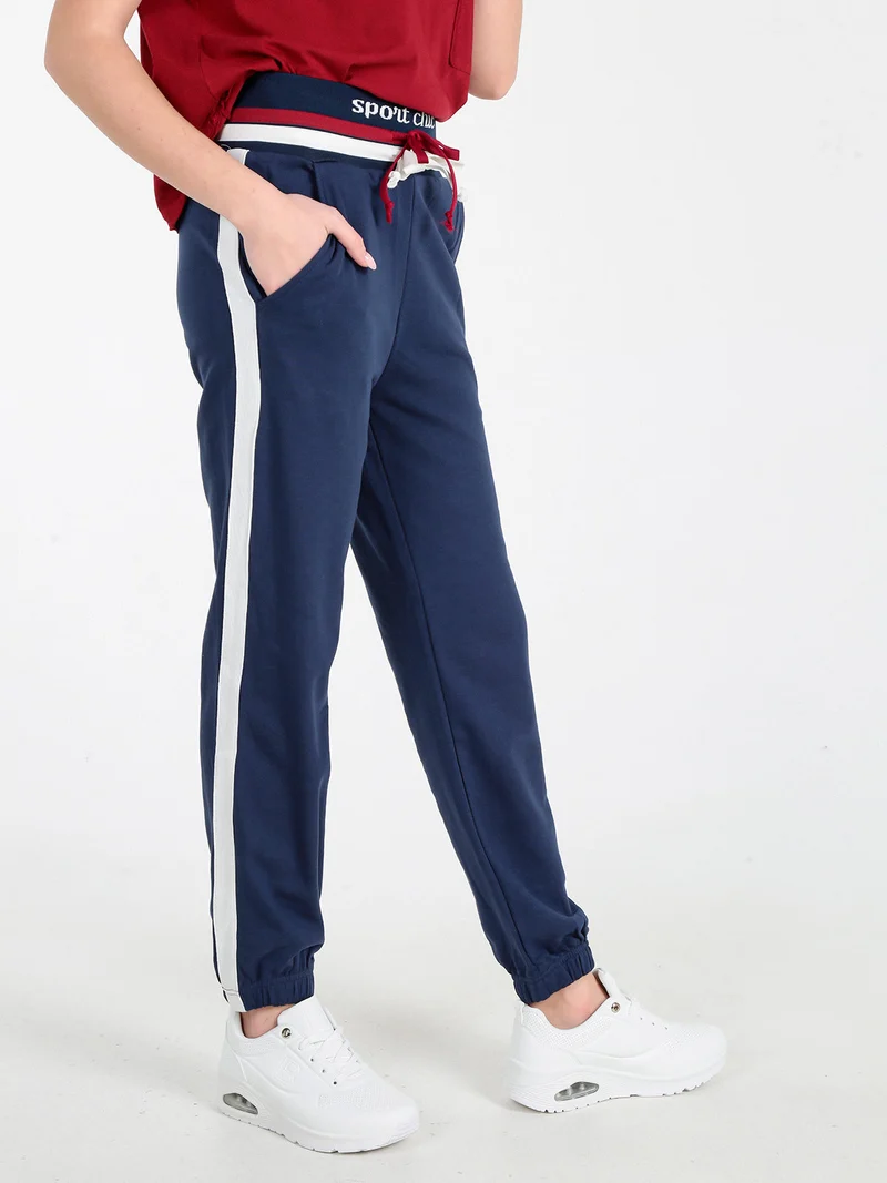 Pantaloni tuta da donna con coulisse e polsini - blu scuro
