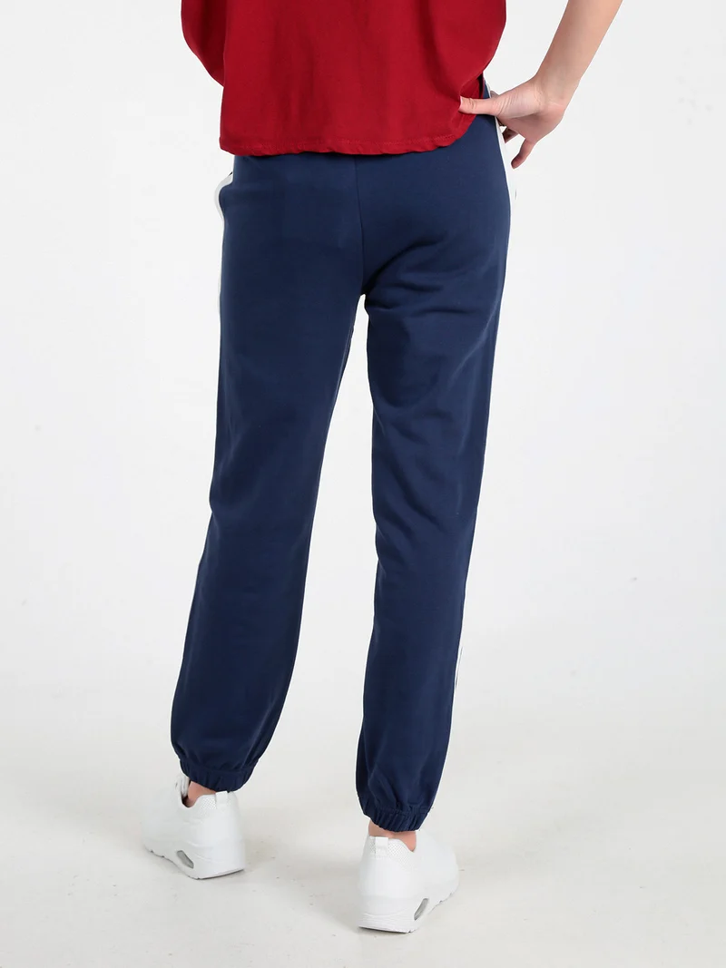 Pantaloni tuta da donna con coulisse e polsini - blu scuro
