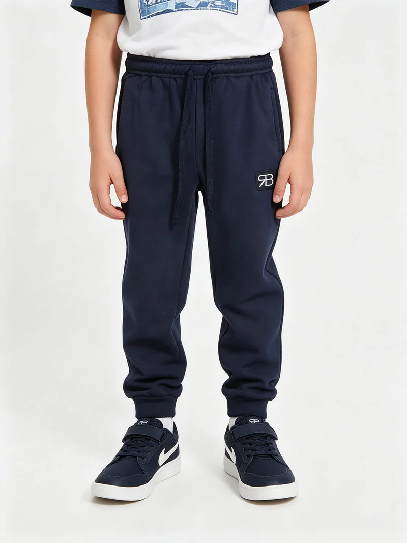 Pantaloni tuta da bambino felpati - blu scuro