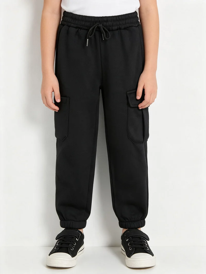 Pantaloni tuta da bambina felpati con tasconi laterali - nero