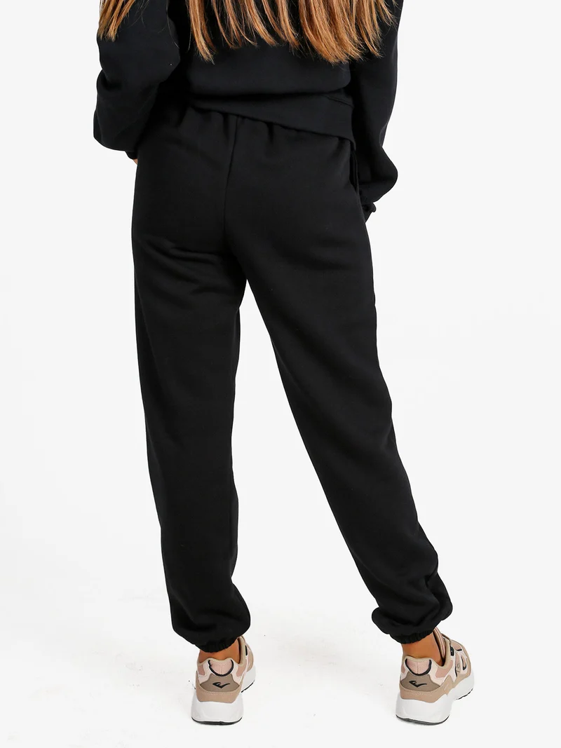 Pantaloni tuta da donna felpati con elastico finale - nero