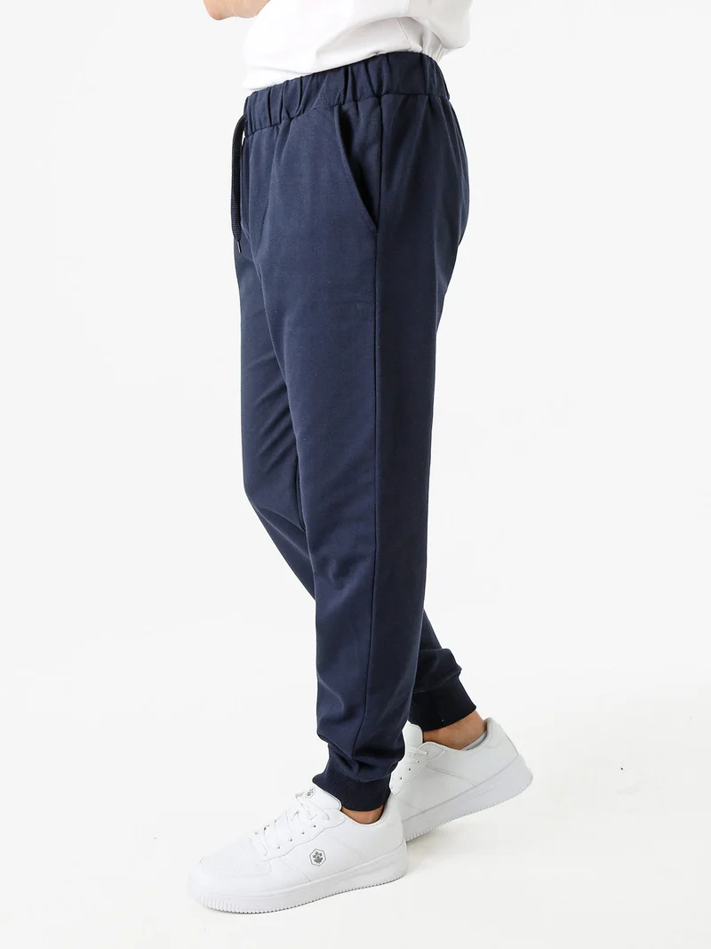 Pantaloni tuta da uomo in felpa con coulisse e polsini - blu scuro
