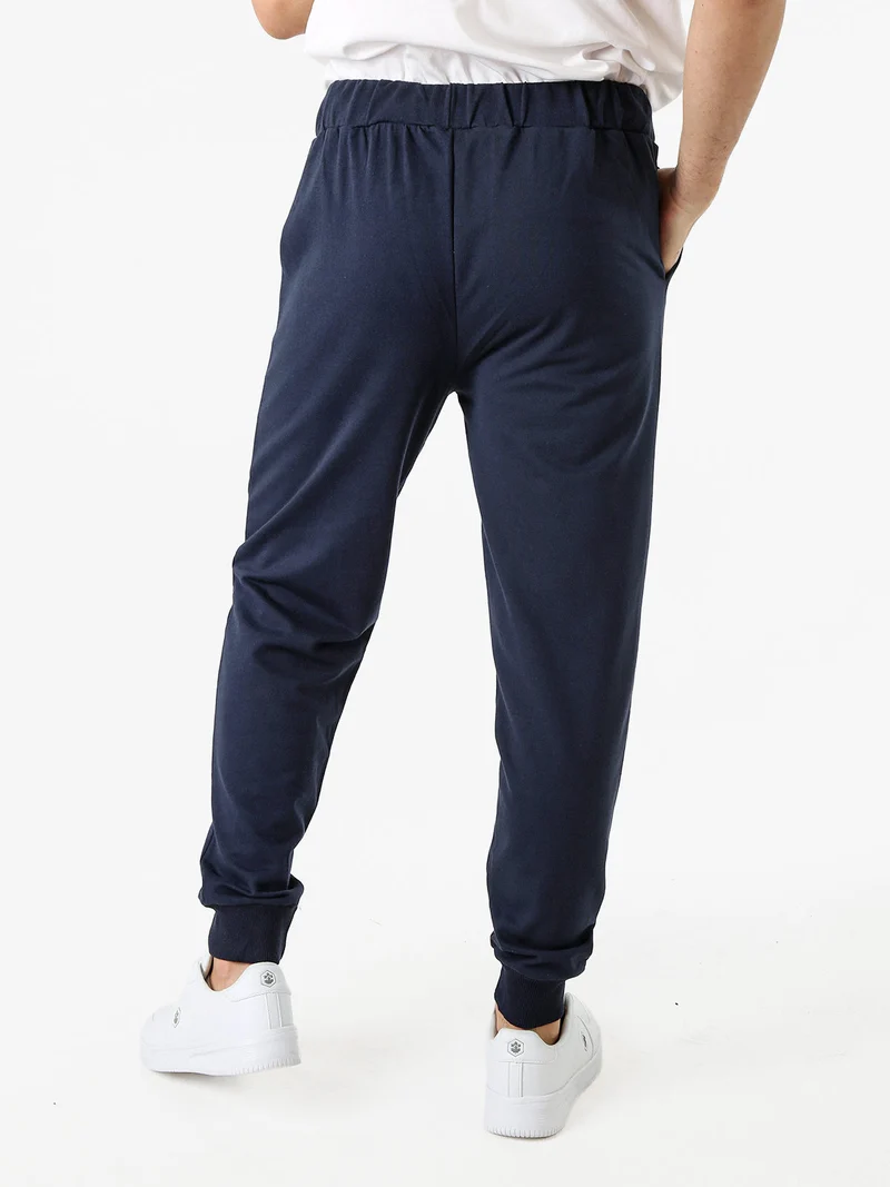 Pantaloni tuta da uomo in felpa con coulisse e polsini - blu scuro