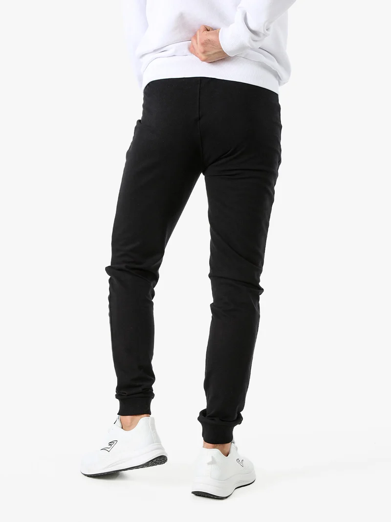 Pantaloni sportivi da uomo in cotone con coulisse e polsini - nero