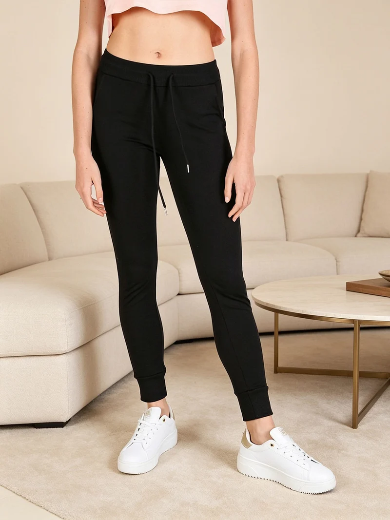 Pantaloni tuta da donna con coulisse e polsini - nero