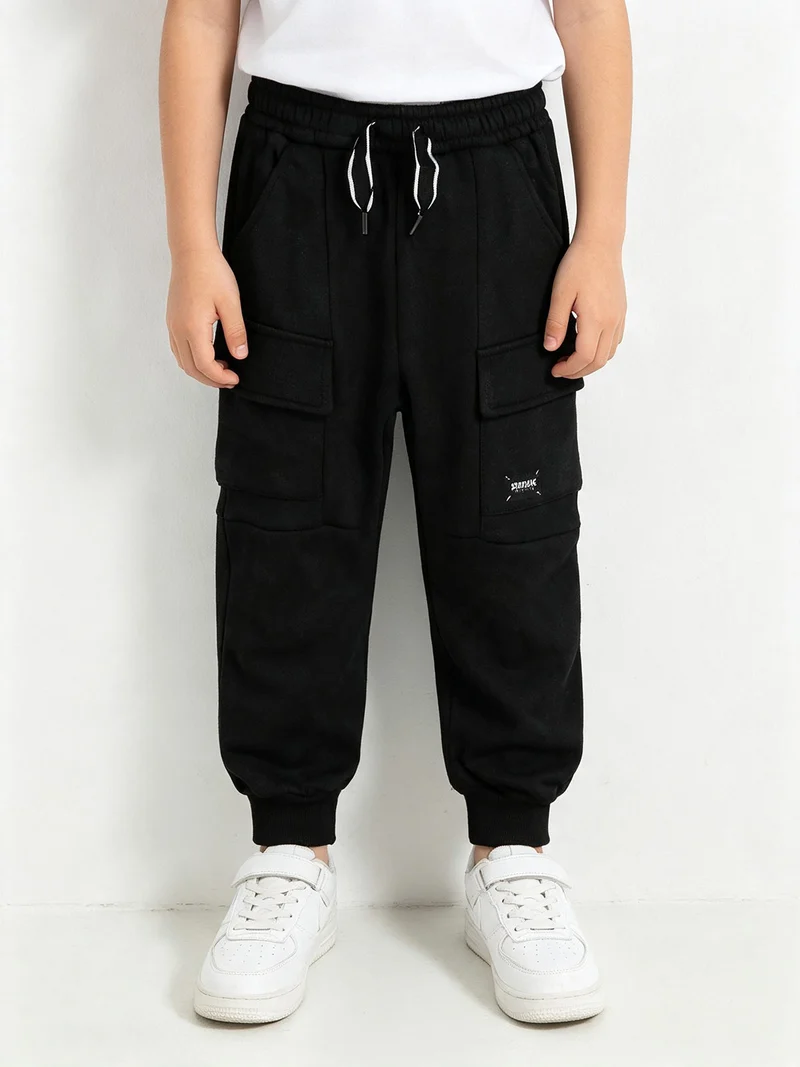 Pantaloni da ragazzo con tasconi e polsini - nero