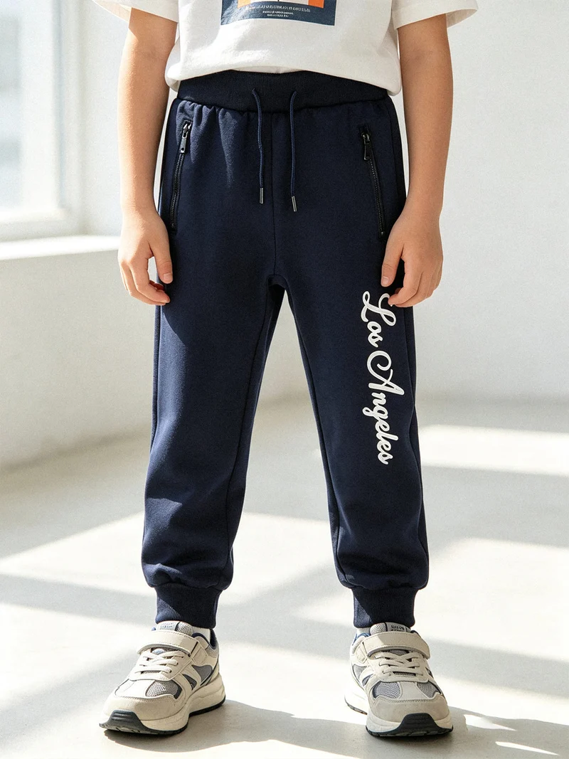 Pantaloni tuta da bambino con polsini e coulisse - blu scuro