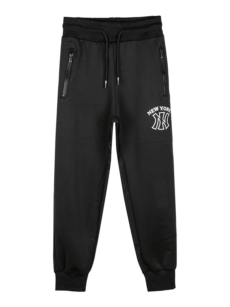 Pantaloni sportivi da bambino con polsini e coulisse - nero