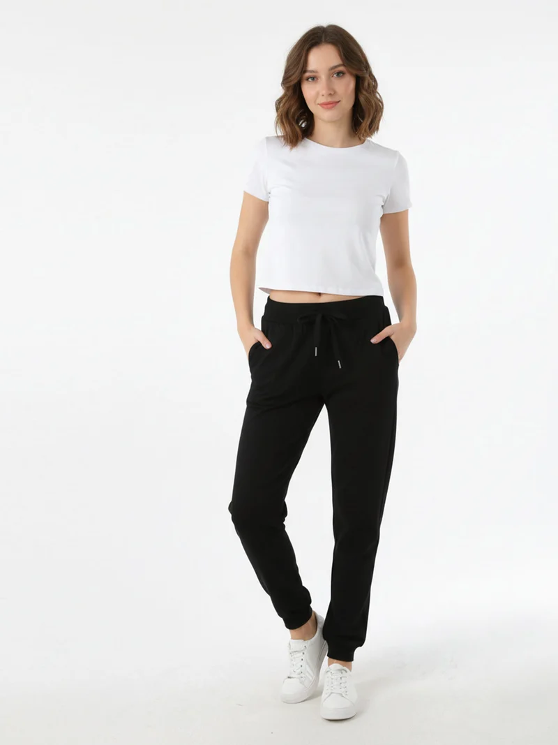 Pantaloni tuta da donna con coulisse e polsini - nero