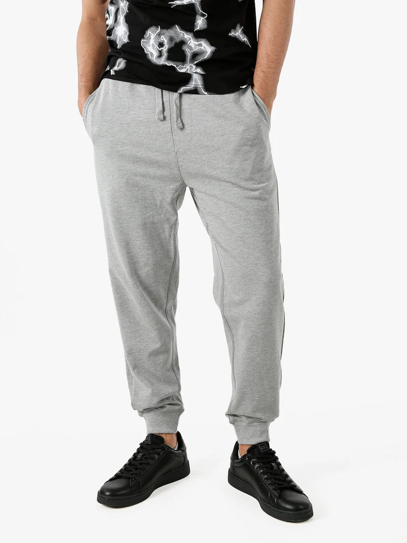 Pantaloni tuta da uomo con coulisse e polsini - grigio