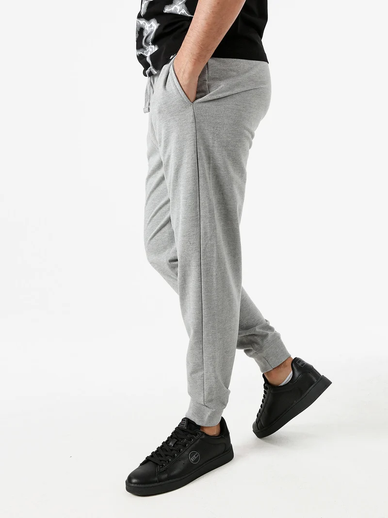 Pantaloni tuta da uomo con coulisse e polsini - grigio