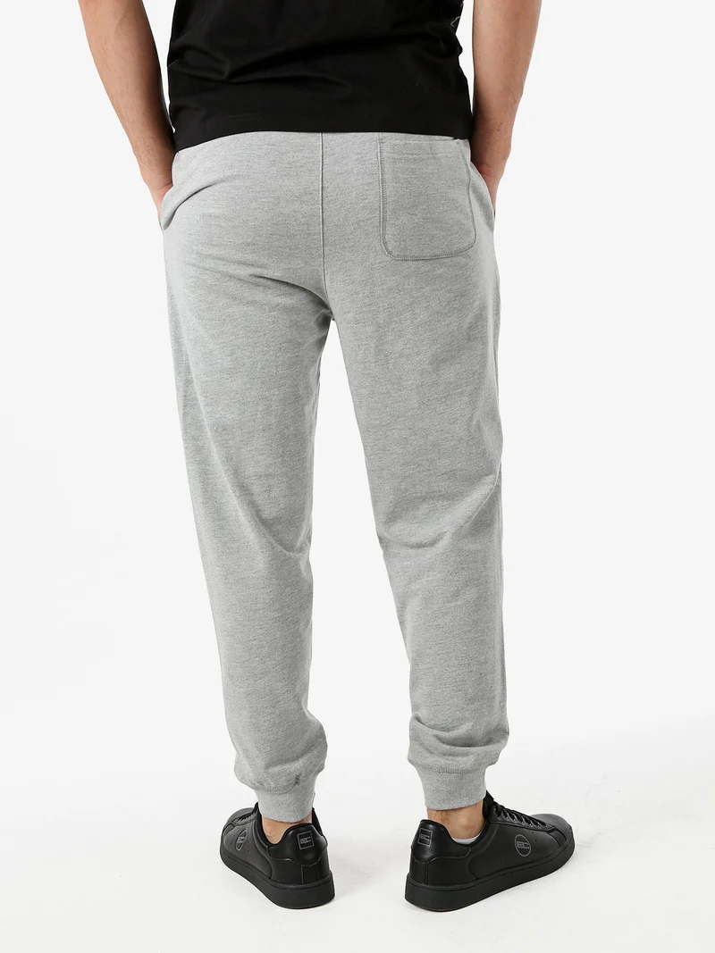 Pantaloni tuta da uomo con coulisse e polsini - grigio