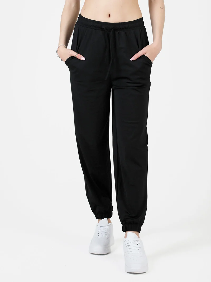 Pantaloni donna in tessuto tecnico con polsini - nero