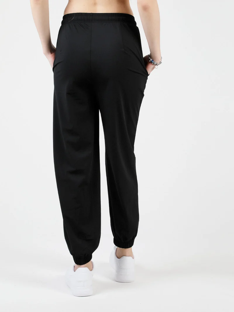 Pantaloni donna in tessuto tecnico con polsini - nero