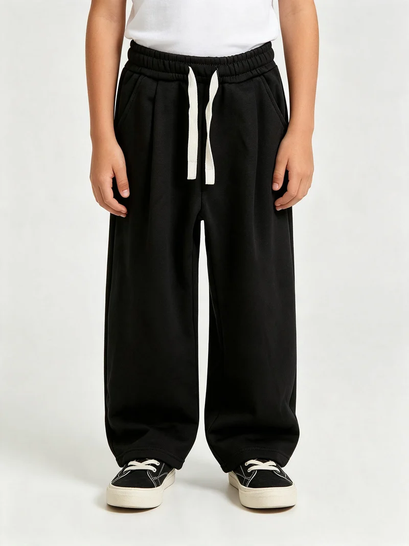 Pantaloni tuta da ragazzo in felpa con coulisse e interno felpato - nero