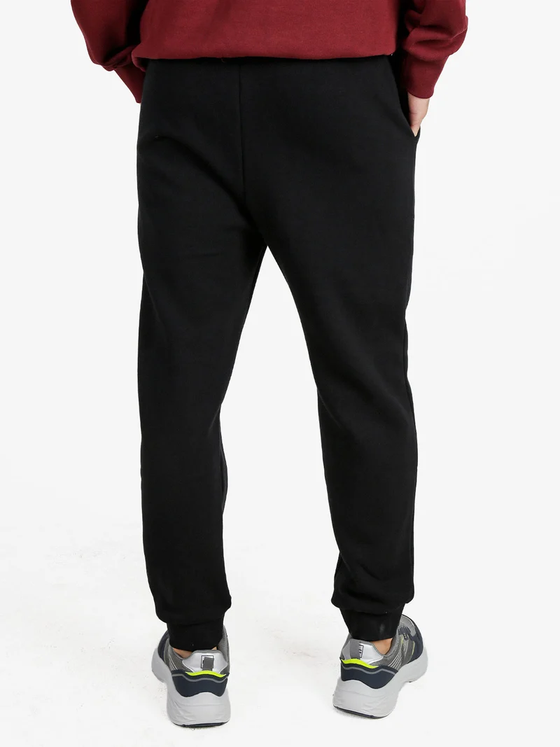 Pantaloni tuta da uomo felpati con polsini - nero