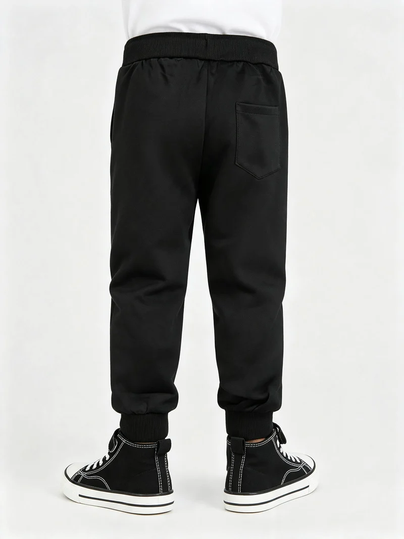 Pantaloni tuta da bambino con coulisse e polsini - nero