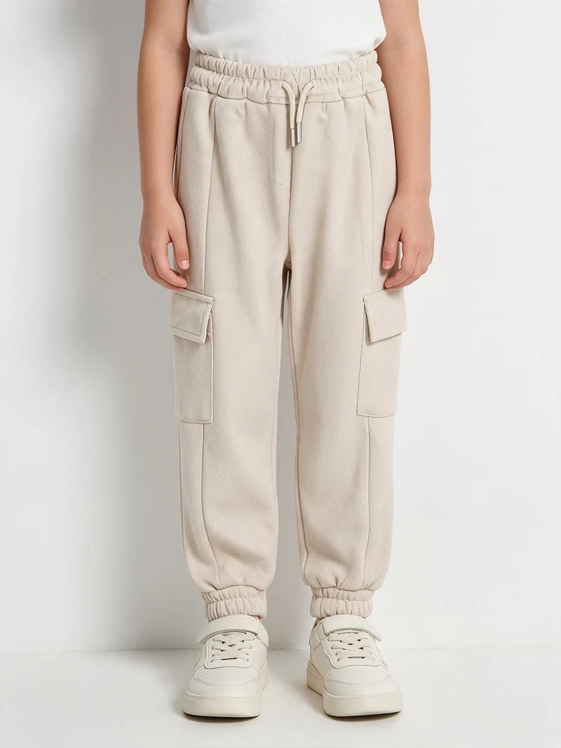 Pantaloni tuta da bambina con tasconi laterali - beige