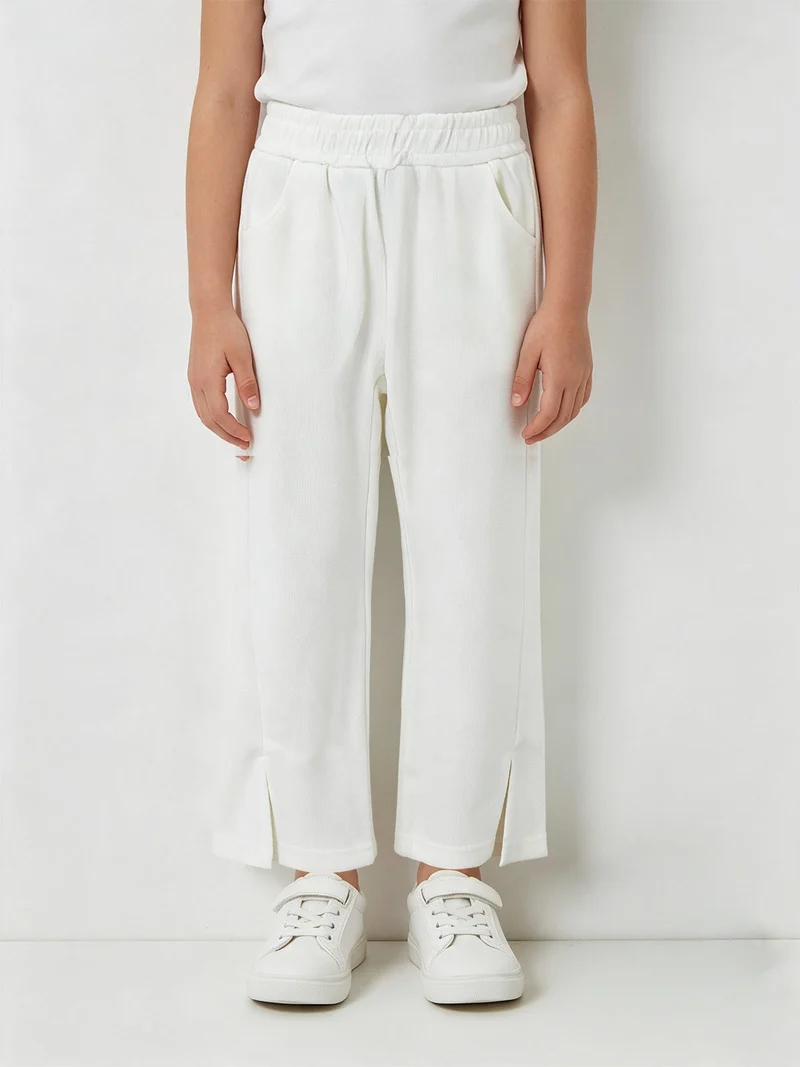 Pantaloni pesanti da bambina con spacco sul finale - bianco